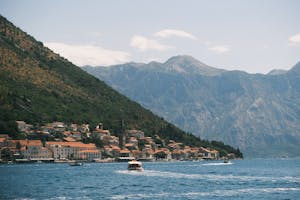 Experience the scenic beauty of Perast in the Bay of Kotor with mountainous backdrop.